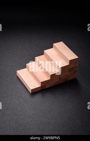 Wooden steps made of blocks as an idea of investment and profit growth in achieving a goal. Background for your idea Stock Photo