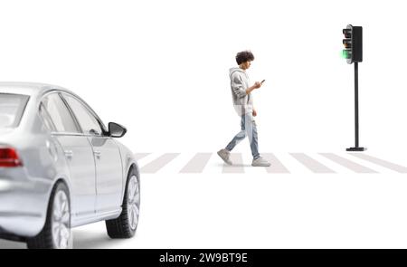 Guy in a gray hoodie crossing a street with a smartphone in his hands isolated on white background Stock Photo