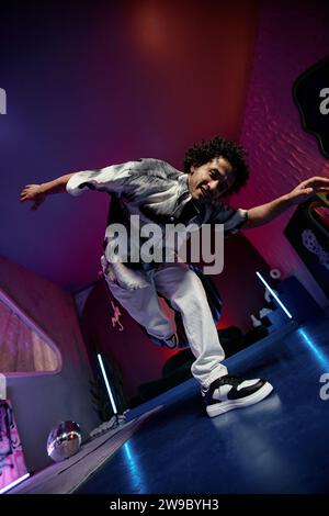 Low angle shot of young breakdancer balancing on one leg, posing and looking at camera Stock Photo