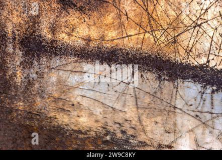 An abstract photograph of a pattern of scratches on a rusted metal surface Stock Photo