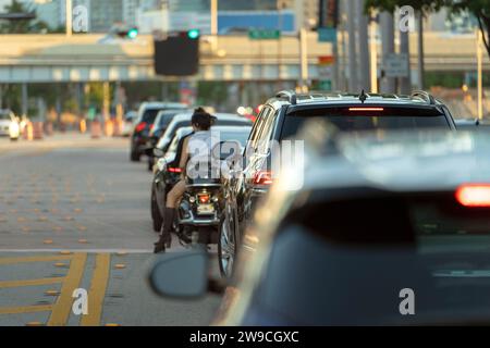 Traffic lights regulating driving cars on city street in Miami, Florida Stock Photo