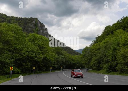 Automobile on motorway driving through Slovakian mountains and forest. Stock Photo