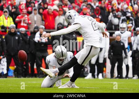 Las Vegas Raiders place kicker Daniel Carlson (2) kicks a 24-yard field goal out of the hold of punter AJ Cole (6) in the first quarter during an NFL Football game against the Kansas City Chiefs, Monday, Dec. 25, 2023, in Kansas City, Mo. The Raiders defeated the Chiefs 20-14. Stock Photo