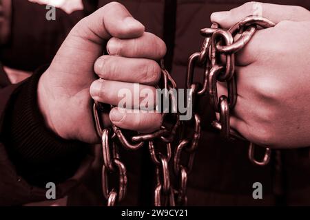 Hand with CHAIN,chain in hand,the chain wound on the hand,dirty hands,black background Stock Photo