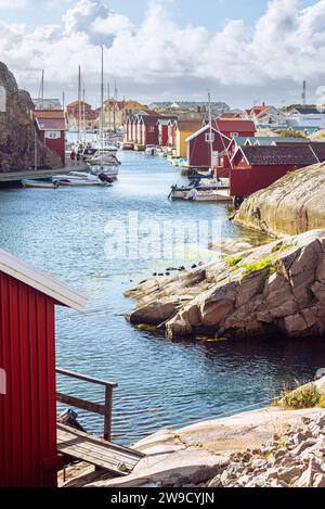 Boat sheds and warehouses with red wooden facades and granite rocks in ...