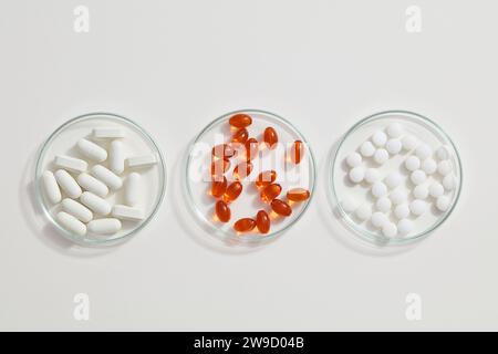 Different types of pills arranged in shape of clock on blue background ...