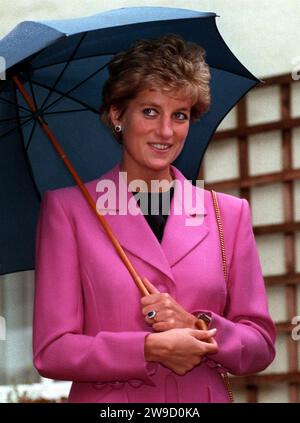 File photo dated 12/10/1993 of the Princess of Wales smiles as she shelters under an umbrella during a visit to the Edward's Trust in Edgbaston, Birmingham. Diana, Princess of Wales showed 'obvious ignorance of, or disregard for, constitutional niceties' in relation to Northern Ireland, according to a note from the Irish ambassador in 1993. The late princess had referred to Northern Ireland as part of Ireland in an interaction which was noted ahead of a historic visit by then-Irish president Mary Robinson to Buckingham Palace. Issue date: Wednesday December 27, 2023. Stock Photo