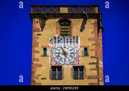 Ornate medieval clock tower with gargoyles in a popular village on the Alsatian Wine Route, in Ribeauville, France Stock Photo