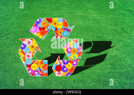 The international symbol for recycling, reuse, with floral pattern of many different flowers and colors, symbol for nature conservation, environmental Stock Photo