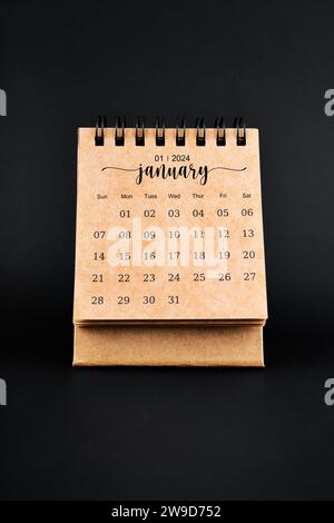 January 2024 desk calendar black and white color with pencil on orange ...