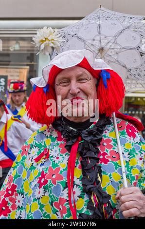 man dress up like a lady dressed as woman, a member of the Moulton Morris Men , at a Christmas fund raising event, Northampton, UK Stock Photo CIJDS50