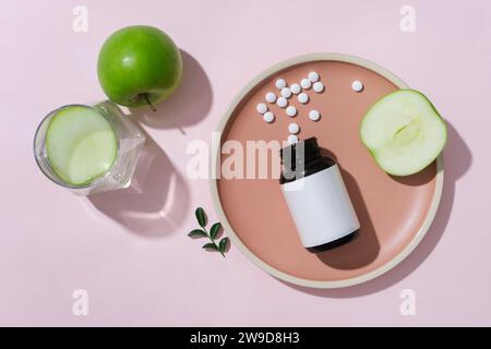 Products with ingredients from green apples are displayed on round plates for advertising. Green apples contain antioxidants, which help regenerate an Stock Photo