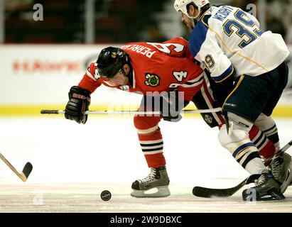 Chicago, USA. 17th Oct, 2007. Chicago Blackhawks' Yanic Perreault battles St. Louis Blues' Doug Weight for the puck on Oct. 17, 2007, in Chicago. (Photo by Charles Cherney/Chicago Tribune/TNS/Sipa USA) Credit: Sipa USA/Alamy Live News Stock Photo