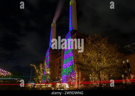 ipad Christmas designs projected on to the iconic chimneys of Battersea Power Station at Christmas 2023 Stock Photo