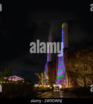 ipad Christmas designs projected on to the iconic chimneys of Battersea Power Station at Christmas 2023 Stock Photo