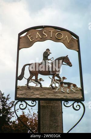 Village sign depicting horse and huntsman with hounds, for Easton, Suffolk, England, UK June 1975 Stock Photo