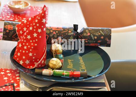 Christmas Table settings, with crackers, festive decorations, place settings, ready for dining, eating Christmas Dinner Stock Photo