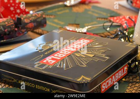 An Art Deco Scrabble board special edition on the corner of a festively decorated Christmas Dining Table Stock Photo