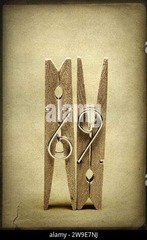 Two wooden clothes pegs with texture overlay Stock Photo