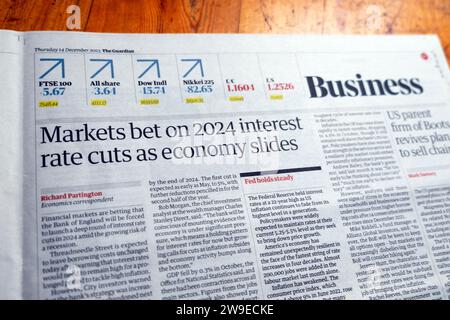 'Markets bet on 2024 interest rate cuts as economy slides' in Britain Guardian newspaper headline Business article on 14 December 2023 London UK Stock Photo