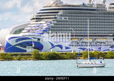 Miami, Florida, USA - 5 December 2023: Cruise ship Norwegian Viva docked in the port of Maimi with a small sailing boat in the foreground Stock Photo