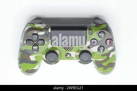 Ocala, Florida November 2023 Video game remote controller game pad isolated on a light white background. green camouflage color top view with buttons Stock Photo
