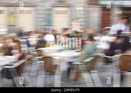 Motion effect in photography. Slow time exposure. Outdoor restaurant ...