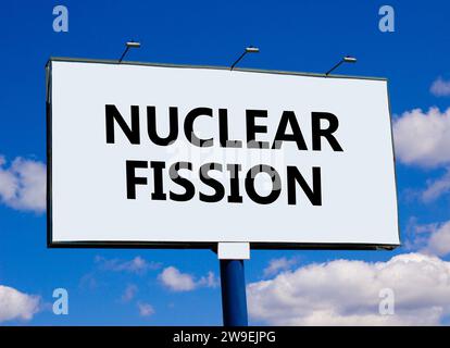 Nuclear fission symbol. Concept words Nuclear fission on beautiful big white billboard. Beautiful blue sky cloud background. Business science nuclear Stock Photo