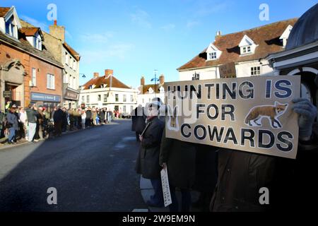 Bungay, UK. 26th Dec, 2023. A protester holds a placard saying ‘Hunting Is For Cowards' during the demonstration. Action Against Animal Cruelty, protest was held in the town centre, Bungay as the Waveney and Norfolk Harriers parade through the streets supporting the countryfolk. The protesters said that despite their being a ban on traditional fox hunting, animals are still being killed during the trail hunting alternative and they are calling for a total ban. (Photo by Martin Pope/SOPA Images/Sipa USA) Credit: Sipa USA/Alamy Live News Stock Photo