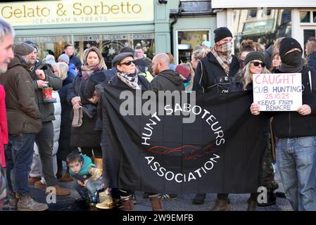 Bungay, Suffolk, UK. 26th Dec, 2023. Protesters from the Hunt Saboteurs Association hold a banner at the roadside waiting for the hunt parade to begin. Action Against Animal Cruelty, protest was held in the town centre, Bungay as the Waveney and Norfolk Harriers parade through the streets supporting the countryfolk. The protesters said that despite their being a ban on traditional fox hunting, animals are still being killed during the trail hunting alternative and they are calling for a total ban. (Credit Image: © Martin Pope/SOPA Images via ZUMA Press Wire) EDITORIAL USAGE ONLY Stock Photo