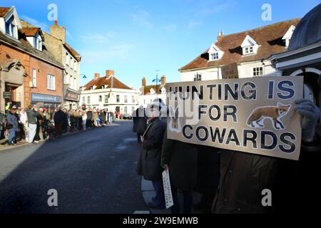 Bungay, Suffolk, UK. 26th Dec, 2023. A protester holds a sign saying ''˜Hunting Is For Cowards' as hunt supporters line the streets of the town centre. Action Against Animal Cruelty protest in the town centre, Bungay as the Waveney and Norfolk Harriers parade through packed streets of supporting country folk. The protesters say that despite their being a ban on traditional fox hunting, animals are still being killed during the trail hunting alternative and they are calling for a total ban. (Credit Image: © Martin Pope/SOPA Images via ZUMA Press Wire) EDITORIAL USAGE ONLY! Not for Commerci Stock Photo