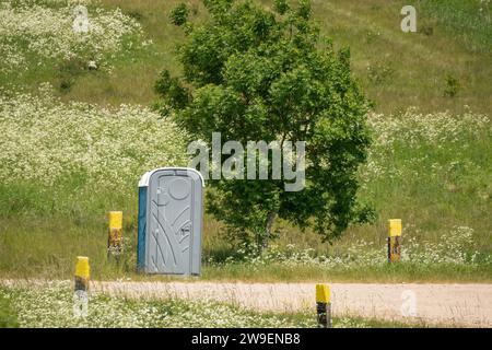 a portable self-contained portaloo toilet in countryside Stock Photo