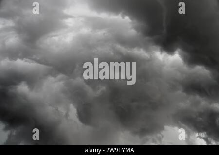 Dark ominous clouds loom over the landscape, threatening an impending storm. Stock Photo