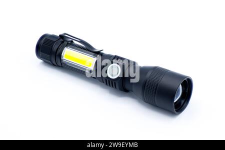 rechargeable battery powered flashlight isolated on white background.   black hard plastic with soft rubber on off button.  yellow LED light on side a Stock Photo