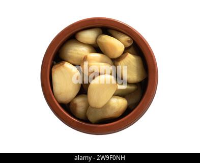 Garlic pickled in Apple cider vinegar with Rock sugar in jar bowl isolated on white background with clipping path. Healthy pickled green and yellow ga Stock Photo