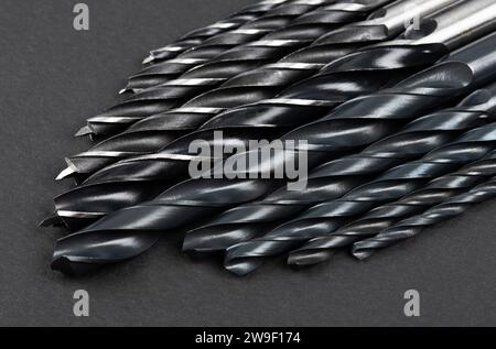 Set of different drill bits on dark background Stock Photo