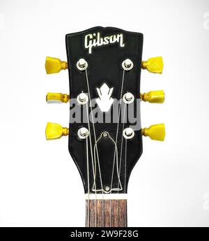 Closeup of guitar tuner or tuning pegs on black headstock.  Classic old school vintage kluson deluxe double ring circa 1966 on Gibson SG solid guitar Stock Photo