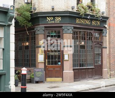 London, UK - March 16 2023; Outside and entrance of Rising Sun pub at number 38 Cloth Fair London Stock Photo