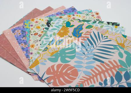 Multicolored patterned sheets of paper for origami on white background Stock Photo