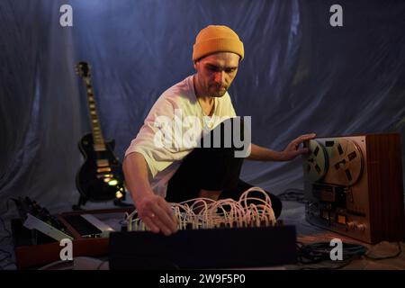 Composer Working on Analog Recording with Tape and Mixing Console Stock Photo