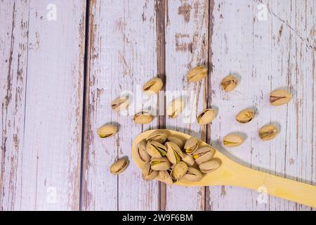 Pile of pistachios in the peel close-up on a white background. Isolated Stock Photo