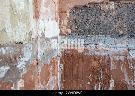 Damaged damp plaster exposing brick in a bathroom. Home improvement problems concept Stock Photo