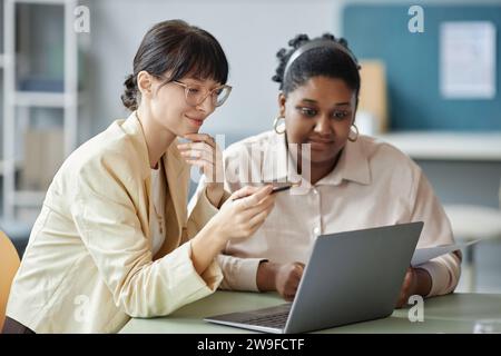 Two Female Colleagues Using Laptop Stock Photo