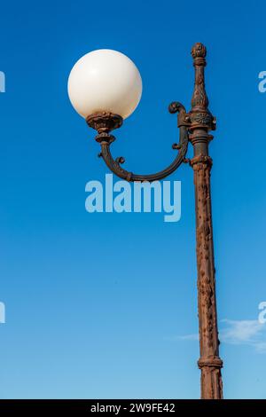 Rusty street lamp in daylight near Marsascala, Malta Stock Photo