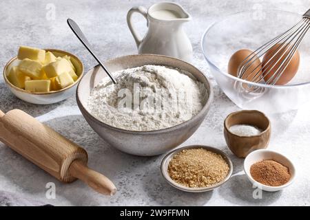 various baking ingredients on light grey painted kitchen table background Stock Photo