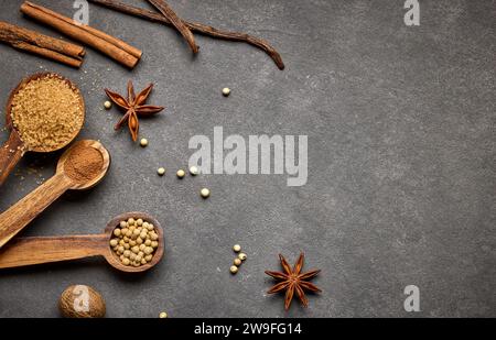various spices for baking on dark grey background, top view Stock Photo