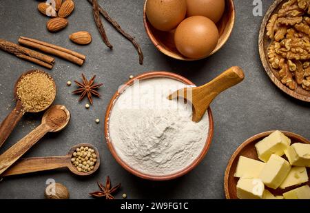 various baking ingredients on dark grey background Stock Photo