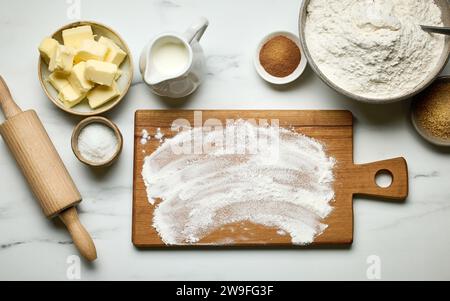 various baking ingredients on light grey painted kitchen table background, top view Stock Photo