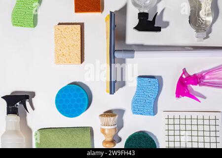 Various cleaning tools and supplies on white background, long shadows, view from the top. Spring cleaning concept Stock Photo