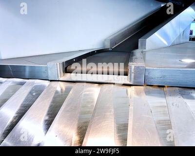 A baggage carousel at an airport terminal Stock Photo